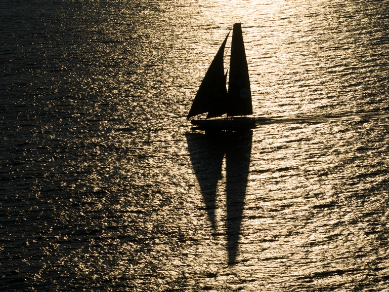 The Ocean Race 2022-23 - 22 June 2023, Leg 7, Day 7 onboard 11th Hour Racing. The 11th Hour Racing Team delivering Malama to Genoa, Italy, after completing repairs to the damaged port side and retiring from the leg. Malama approaching Finisterre at sunset.