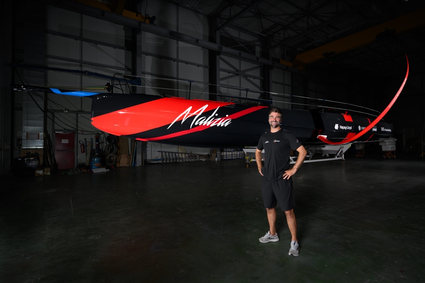Boris Herrmann standing in front of Malizia 4 the day before she was rolled out of the hangar for the first time.
